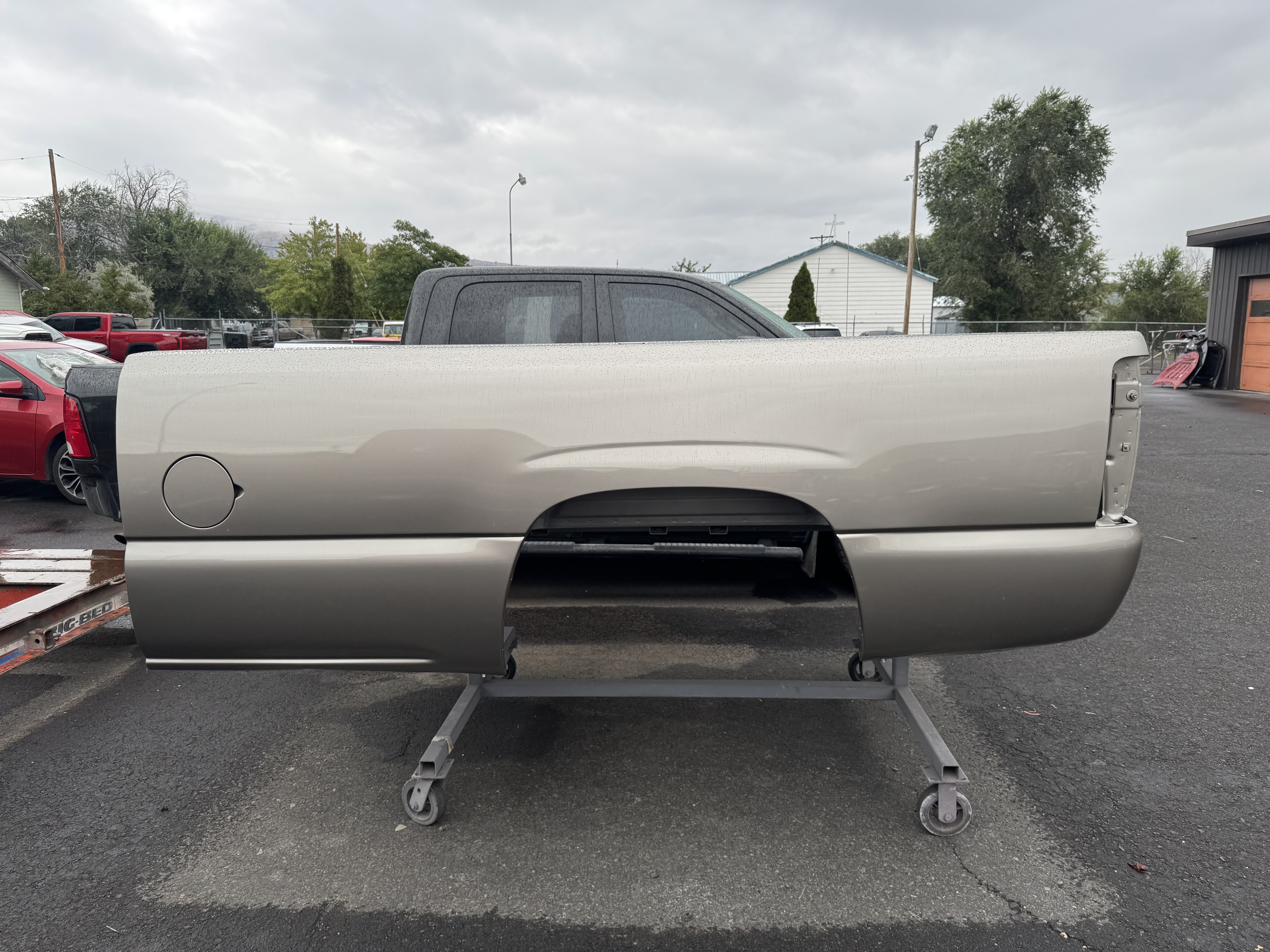 repaired silver truck bed panel prepared for paint and installation